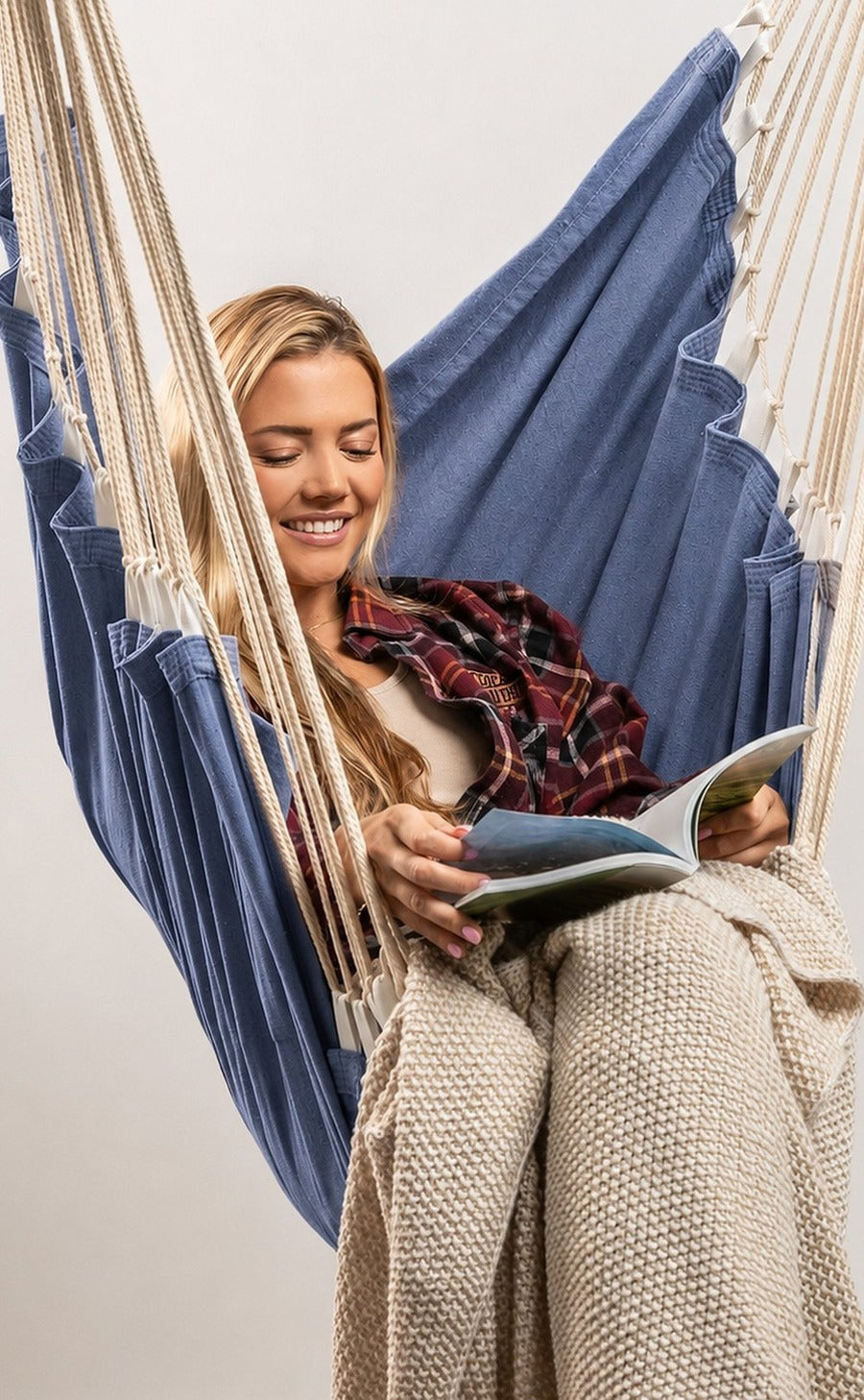 Model relaxing in the Navy Classic Solids hammock chair